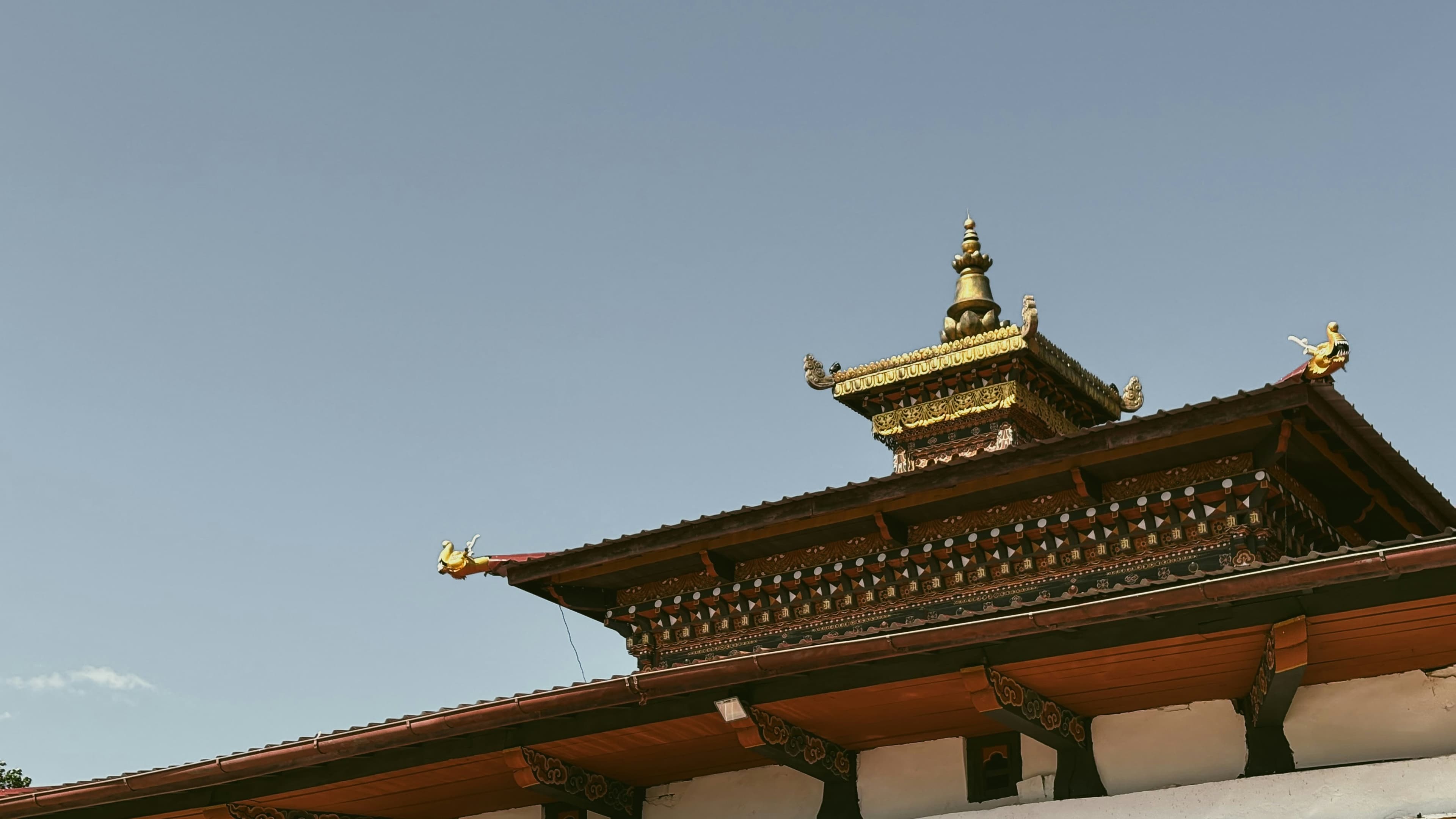Traditional Bhutanese roof architecture with intricate woodwork